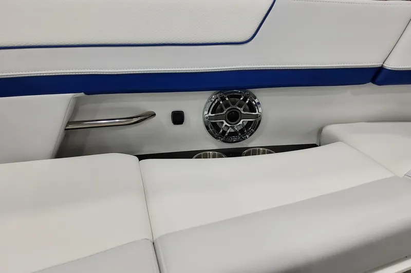  Yacht Photos Pics 2026 Formula 310 Bowrider I/O interior with speaker, cup holders, and white-blue seating.