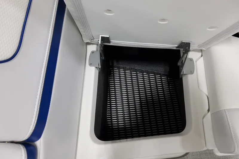  Yacht Photos Pics Open storage compartment in 2026 Formula 310 Bowrider I/O boat, featuring white and blue seating.
