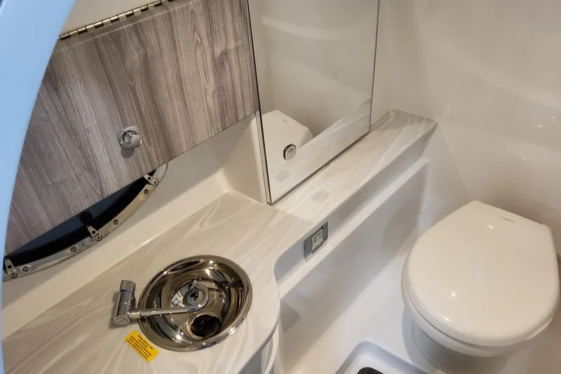  Yacht Photos Pics 2026 Formula 310 Bowrider I/O boat bathroom with modern sink and toilet.