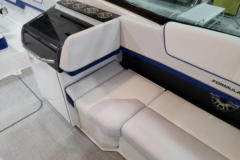  Yacht Photos Pics 2026 Formula 310 Bowrider I/O interior with white seating and cup holders.