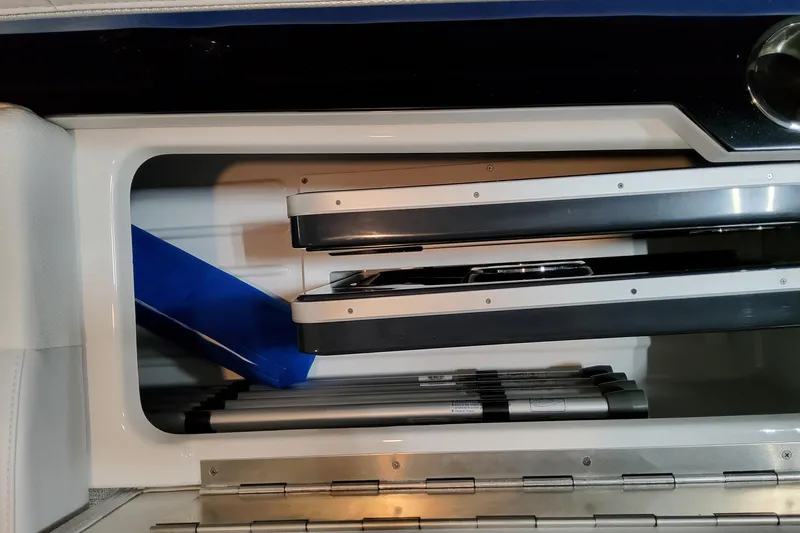  Yacht Photos Pics Storage compartment in 2026 Formula 310 Bowrider I/O boat, featuring neatly stacked equipment.