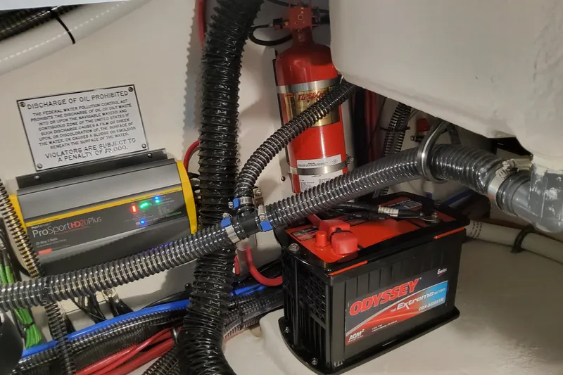  Yacht Photos Pics 2026 Formula 310 Bowrider I/O engine compartment with battery, charger, and fire extinguisher.