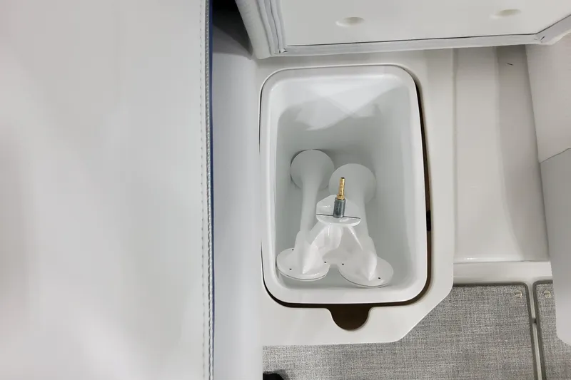  Yacht Photos Pics 2026 Formula 310 Bowrider I/O boat interior storage compartment with white plastic fittings.