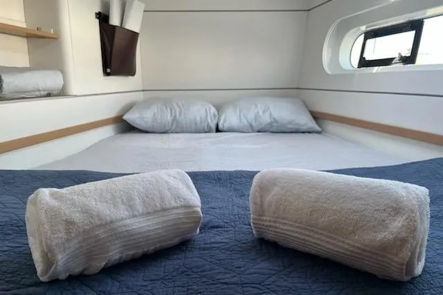  Yacht Photos Pics Cozy cabin interior of 2020 Excess 12 yacht with neatly arranged towels and bedding.