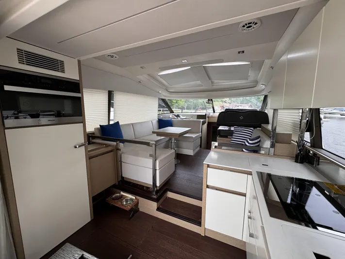  Yacht Photos Pics Luxurious interior of a 2020 Prestige 460S yacht with modern kitchen and seating area.