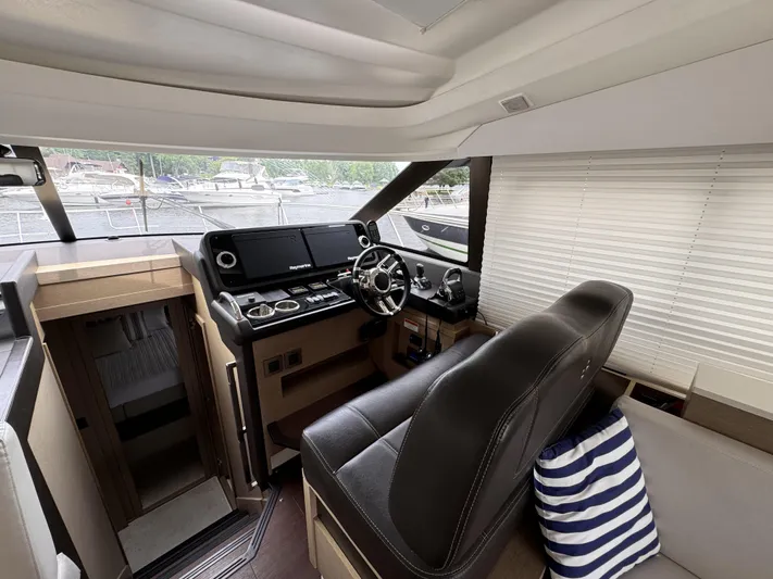  Yacht Photos Pics Prestige 460S 2020 yacht interior helm with leather seating and striped pillow.
