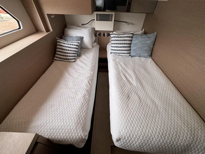  Yacht Photos Pics Twin beds in a 2020 Prestige 460S yacht cabin with striped pillows.