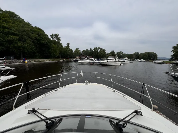  Yacht Photos Pics Bow view of a 2020 Prestige 460S yacht navigating a marina with surrounding boats.