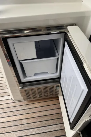  Yacht Photos Pics Open mini fridge on a 2020 Prestige 460S yacht, showing interior storage.