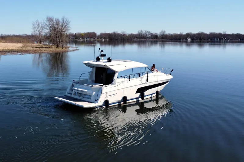  Yacht Photos Pics 2020 Prestige 460S yacht cruising on a calm lake under a clear blue sky.