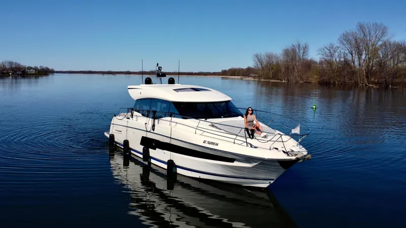  Yacht Photos Pics 2020 Prestige 460S yacht cruising on a serene lake with clear blue skies.