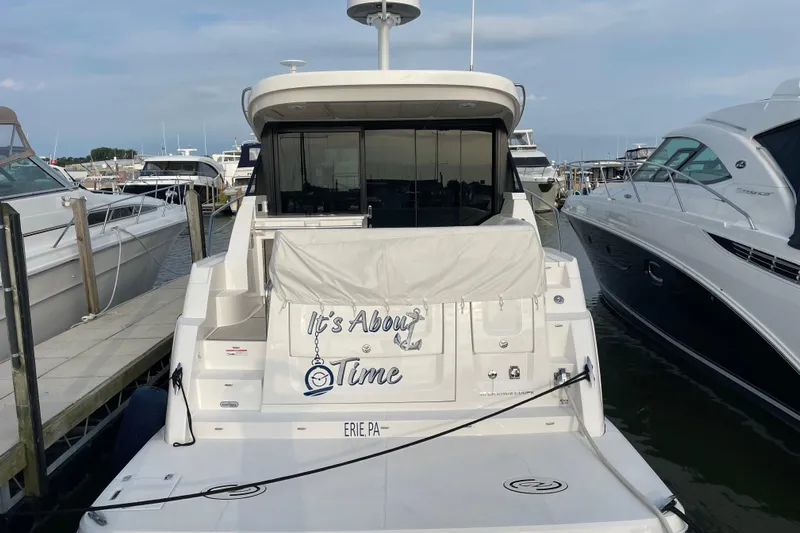It's About Time Yacht Photos Pics 2022 Regal 38 Grande Coupe yacht docked at marina, rear view.