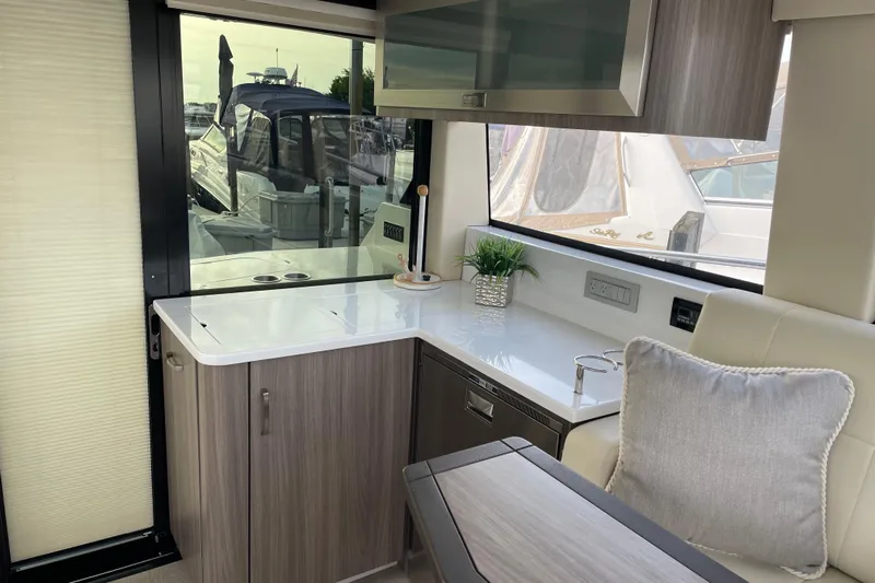 It's About Time Yacht Photos Pics Interior of 2022 Regal 38 Grande Coupe yacht with modern kitchen and seating area.