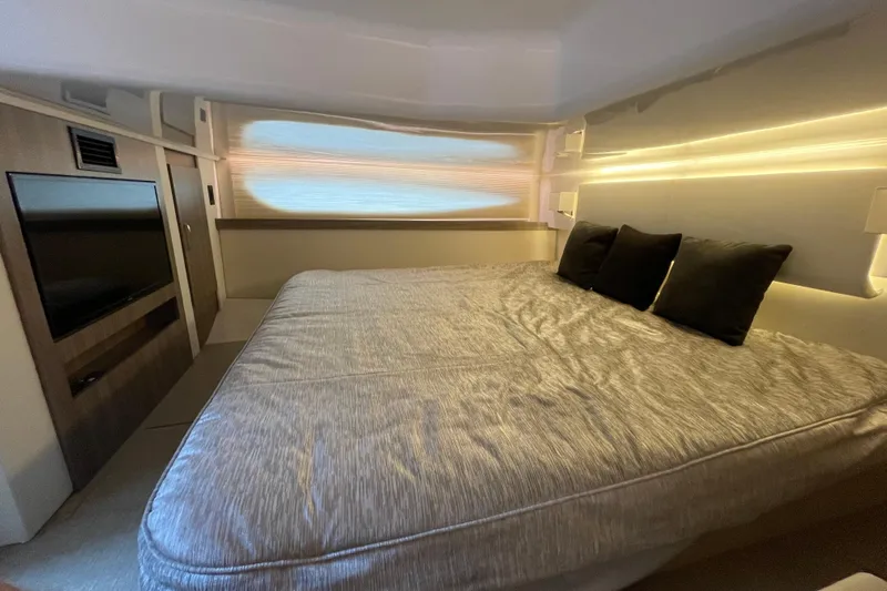 It's About Time Yacht Photos Pics Luxurious bedroom interior of 2022 Regal 38 Grande Coupe yacht with modern lighting.