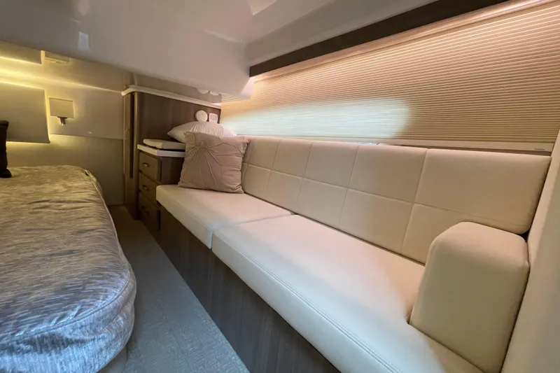 It's About Time Yacht Photos Pics Luxurious interior of 2022 Regal 38 Grande Coupe with elegant seating and bedding.