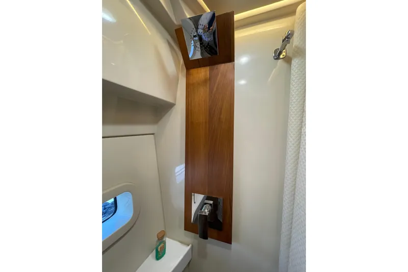 It's About Time Yacht Photos Pics Bathroom interior of 2022 Regal 38 Grande Coupe yacht, featuring modern fixtures and wood accents.