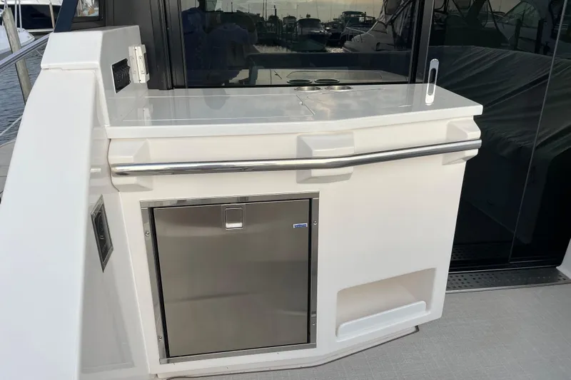 It's About Time Yacht Photos Pics Outdoor kitchenette on 2022 Regal 38 Grande Coupe yacht with stainless steel fridge.