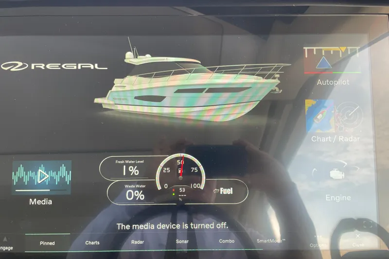 It's About Time Yacht Photos Pics Touchscreen display of a 2022 Regal 38 Grande Coupe showing boat systems and media controls.