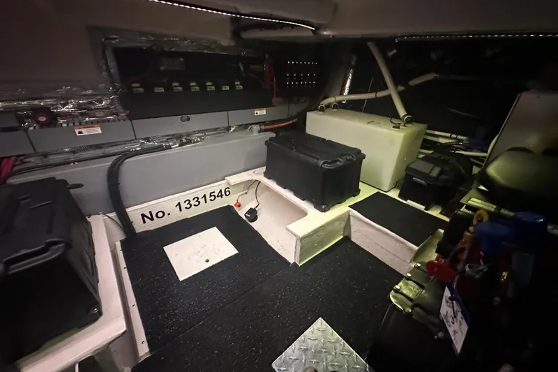 It's About Time Yacht Photos Pics Engine room of 2022 Regal 38 Grande Coupe with equipment and storage cases.