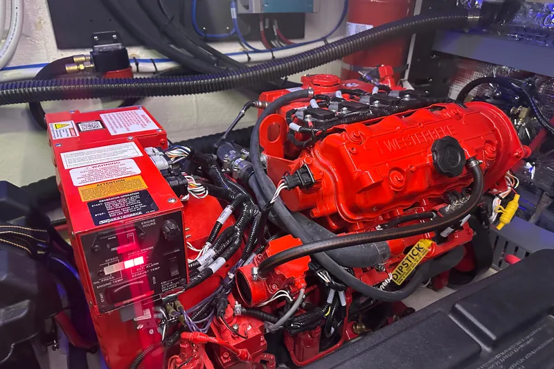 It's About Time Yacht Photos Pics Engine room of 2022 Regal 38 Grande Coupe with red Westerbeke generator.