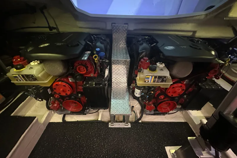 It's About Time Yacht Photos Pics Engine room of 2022 Regal 38 Grande Coupe with dual engines and metallic flooring.