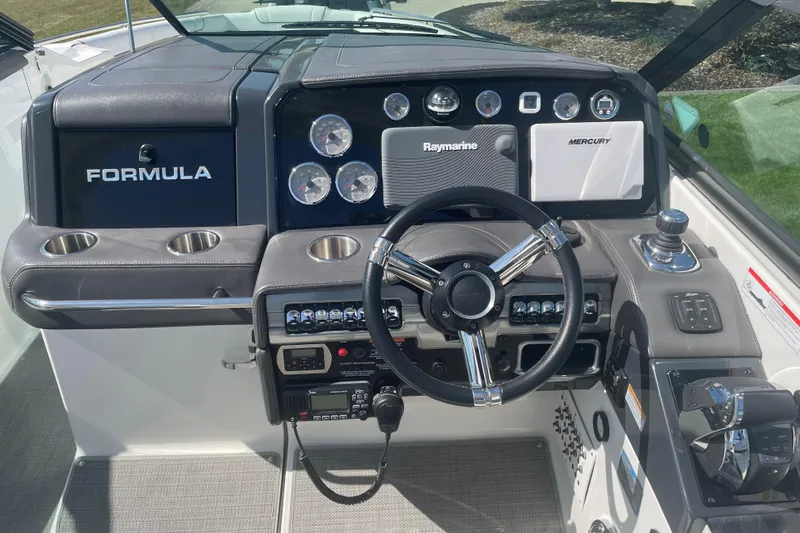  Yacht Photos Pics 2016 Formula 330 Crossover Bowrider dashboard with steering wheel and navigation controls.