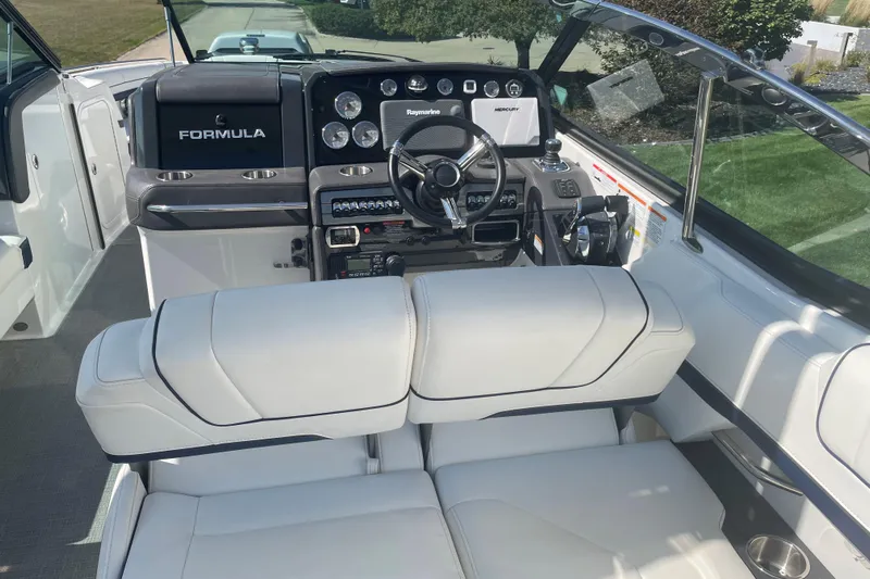  Yacht Photos Pics 2016 Formula 330 Crossover Bowrider cockpit with modern controls and plush seating.