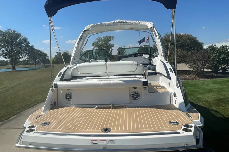  Yacht Photos Pics 2016 Formula 330 Crossover Bowrider boat with spacious deck and seating, docked outdoors.