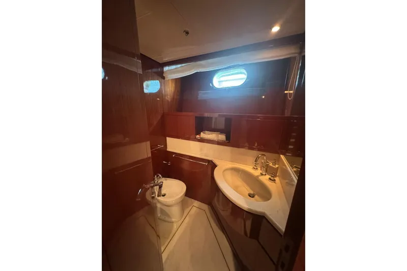  Yacht Photos Pics Luxurious bathroom on 2003 Sanlorenzo SL88 yacht with elegant wood finish and modern fixtures.