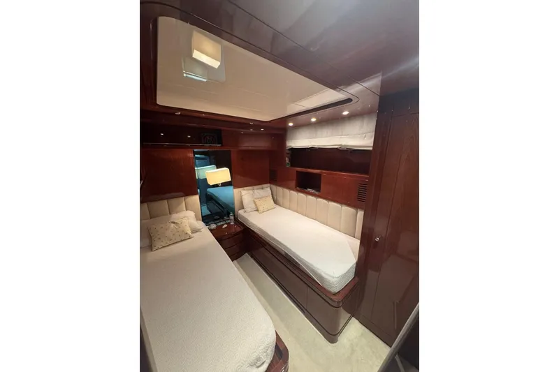  Yacht Photos Pics Luxurious cabin interior of 2003 Sanlorenzo SL88 yacht with twin beds and elegant wood finish.