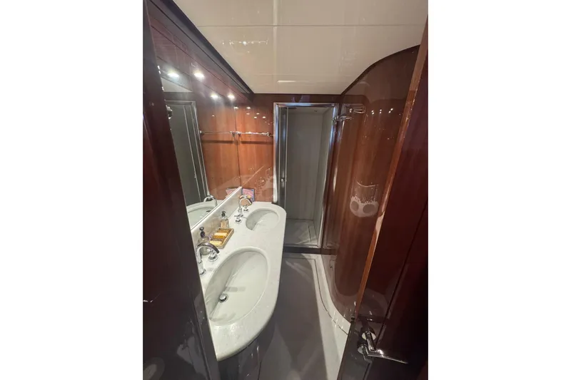  Yacht Photos Pics Luxurious bathroom in 2003 Sanlorenzo SL88 yacht with elegant fixtures and wood paneling.