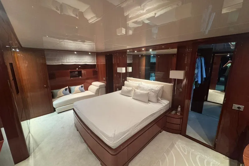  Yacht Photos Pics Luxurious bedroom interior of 2003 Sanlorenzo SL88 yacht with elegant wood finishes.