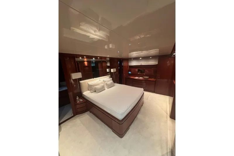  Yacht Photos Pics Luxurious bedroom interior of 2003 Sanlorenzo SL88 yacht with elegant wood finishes.