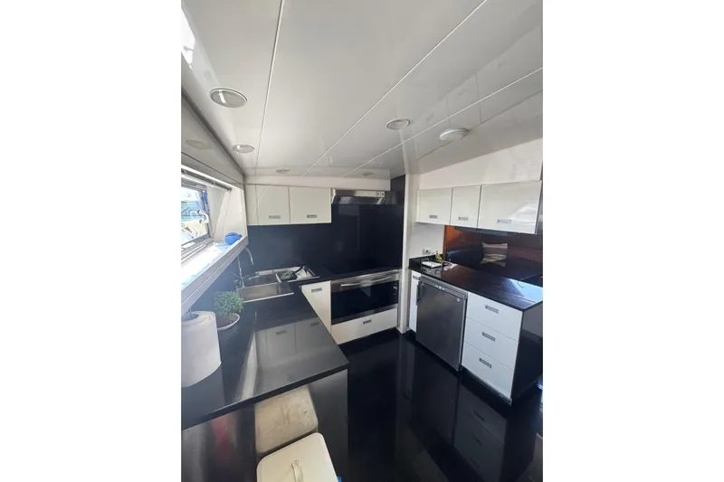  Yacht Photos Pics Modern kitchen interior on 2003 Sanlorenzo SL88 yacht, featuring sleek cabinetry and appliances.