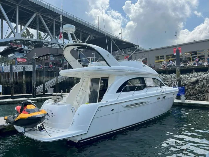  Yacht Photos Pics 2008 Meridian 411 yacht docked near a bridge, with a jet ski attached.