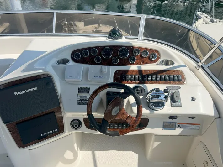  Yacht Photos Pics 2008 Meridian 411 helm with Raymarine navigation, wood accents, and control panel.