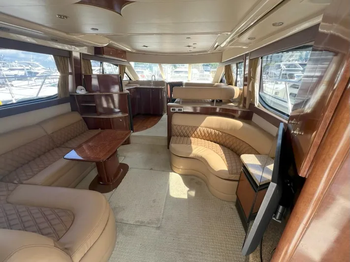  Yacht Photos Pics Luxurious interior of a 2008 Meridian 411 yacht with plush seating and elegant wood finishes.