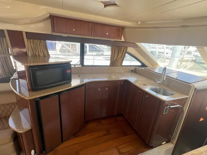  Yacht Photos Pics Luxurious kitchen interior of 2008 Meridian 411 yacht with wood cabinetry and modern appliances.