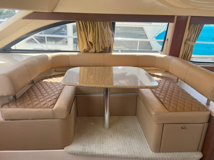  Yacht Photos Pics Luxurious interior of 2008 Meridian 411 yacht with beige leather seating and elegant table.