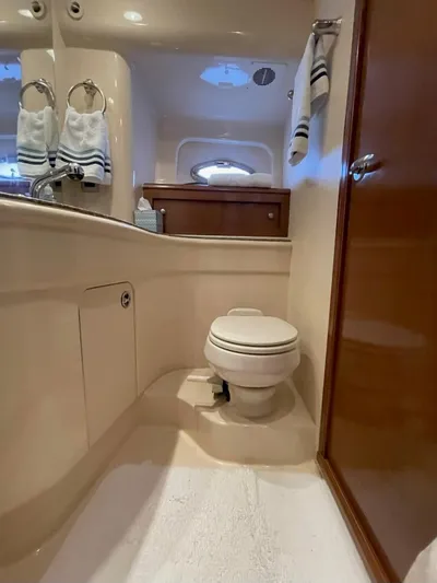  Yacht Photos Pics Luxurious bathroom in a 2008 Meridian 411 yacht, featuring elegant fixtures and striped towels.