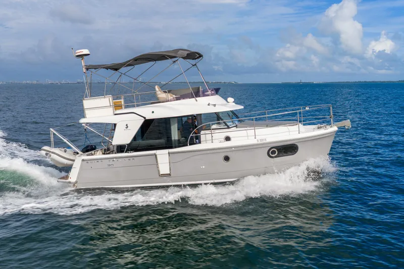  Yacht Photos Pics 2017 Beneteau Swift Trawler 30 cruising on open water under a clear blue sky.