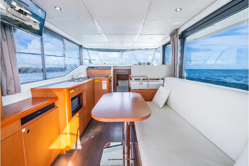  Yacht Photos Pics Interior of 2017 Beneteau Swift Trawler 30 with ocean view, featuring modern seating and kitchen area.