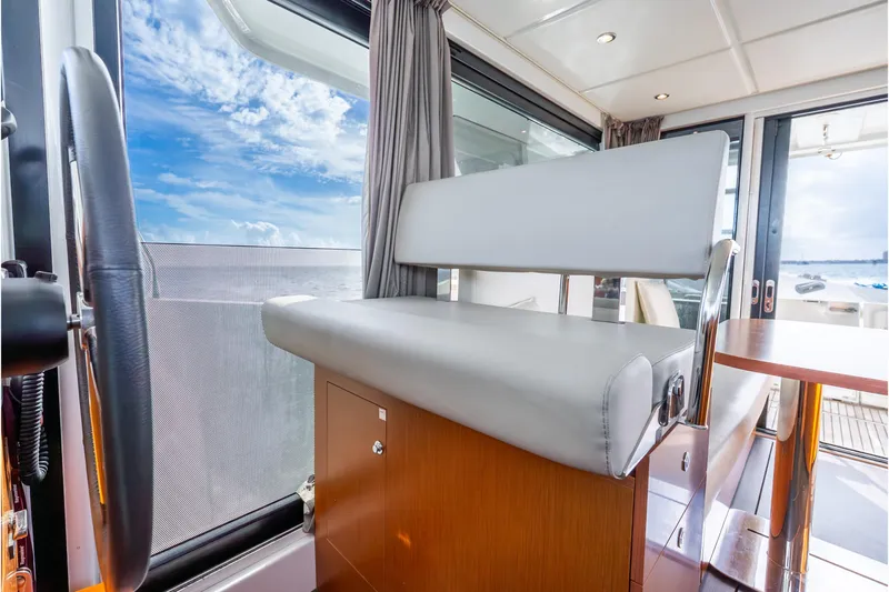  Yacht Photos Pics Interior of 2017 Beneteau Swift Trawler 30 with helm seat and ocean view.