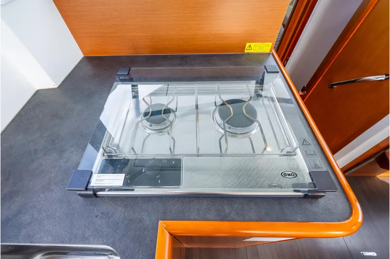  Yacht Photos Pics 2017 Beneteau Swift Trawler 30 kitchen with a two-burner stove and glass cover.