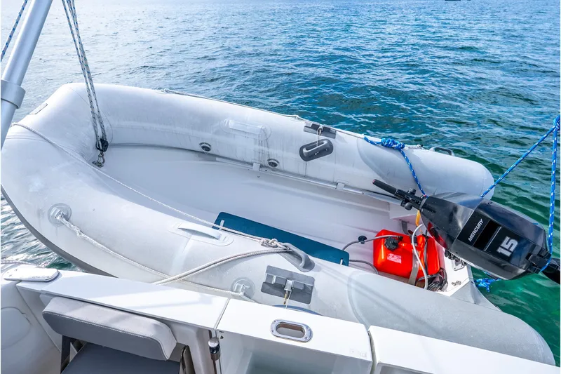  Yacht Photos Pics Inflatable boat with outboard motor on 2017 Beneteau Swift Trawler 30, floating on water.