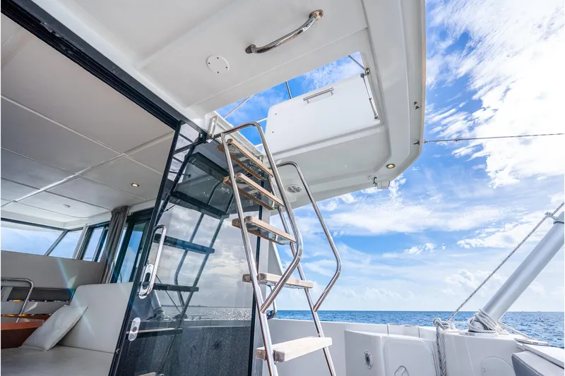  Yacht Photos Pics 2017 Beneteau Swift Trawler 30 interior with stairs, ocean view, and blue sky.