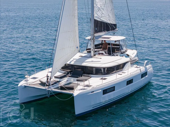 Flying B Yacht Photos Pics 2021 Lagoon 46 catamaran sailing on open sea, featuring sleek design and spacious deck.