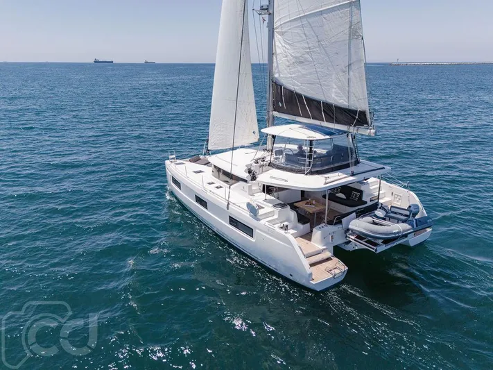 Flying B Yacht Photos Pics 2021 Lagoon 46 catamaran sailing on open sea, showcasing sleek design and spacious deck.