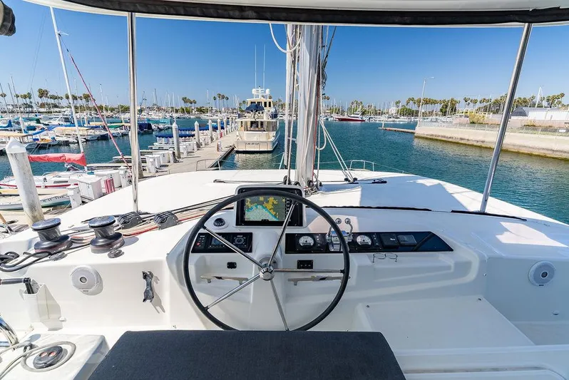 Flying B Yacht Photos Pics Helm of 2021 Lagoon 46 catamaran docked at marina, featuring navigation controls.