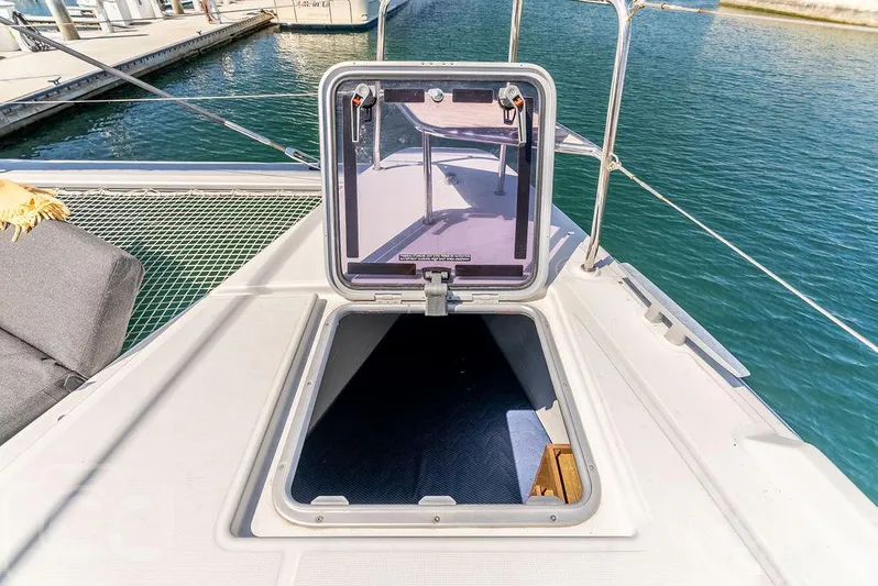 Flying B Yacht Photos Pics Open hatch on 2021 Lagoon 46 catamaran deck, overlooking marina waters.